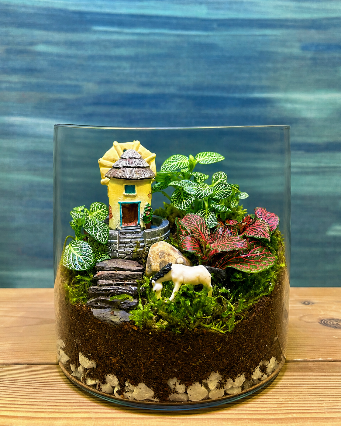 Cottage Garden Terrarium from Planterie, a miniature world of calm with delicate fittonia nestled beside a charming cottage and gentle white horse, creating a cozy tiny landscape perfect as terrarium in Delhi for centre table plant arrangements and plant gifts in Delhi for housewarmings