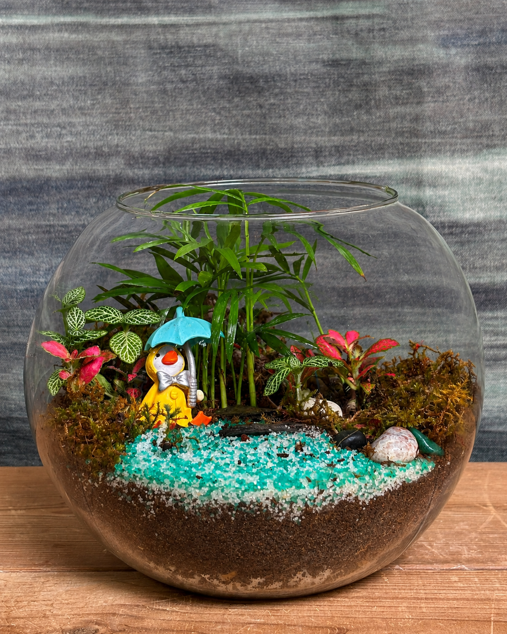 Handcrafted Donald Duck 8-inch Fish Bowl terrarium from Planterie plant studio in Delhi, a unique glass micro-garden with cute Donald Duck miniature and live plants ideal as glass terrarium for gifting, tabletop plants for gifting, indoor plants for gifting and indoor plant gifts for housewarming in Delhi