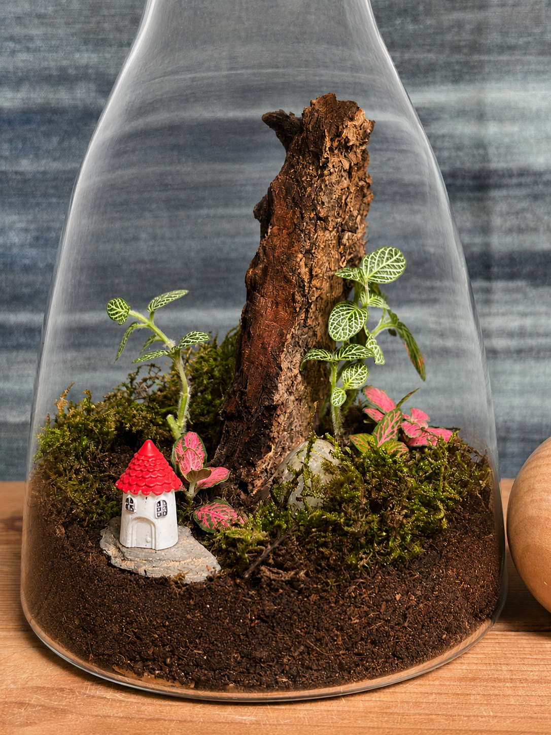 Handcrafted Forest Cottage decanter terrarium from Planterie plant studio in Delhi, a unique glass micro-garden with a cute cottage miniature and live plants ideal as glass terrarium for gifting, tabletop plants for gifting, indoor plants for gifting and indoor plant gifts for housewarming in Delhi