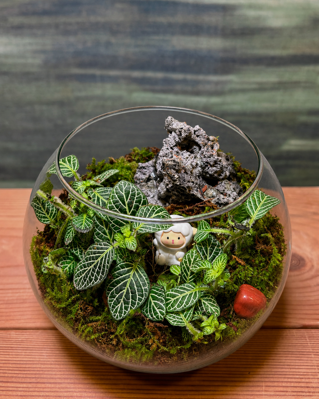 Little Shepherd Garden terrarium from Planterie, a glass terrarium with vibrant pink green fittonia plants and a charming sheep miniature grazing in greenery, perfect terrarium in Delhi for bedside table and plant gifts in Delhi for housewarmings