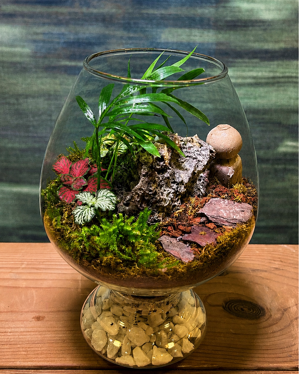 Palm Garden Terrarium from Planterie, a vibrant desktop terrarium featuring a dwarf palm paired with colorful fittonia in red, green and white, creating a lush miniature garden for office desks and centre table plant arrangements in Delhi homes