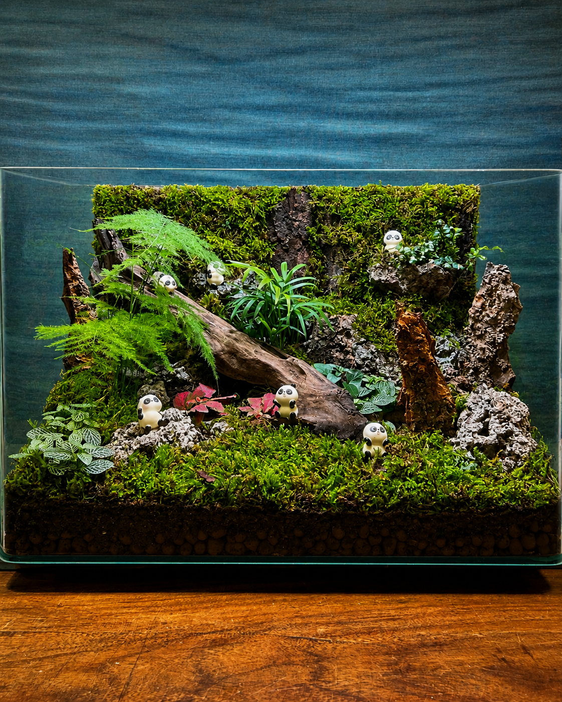 Panda Sanctuary Terrarium from Planterie, a stunning statement glass terrarium featuring lush ferns and vibrant fittonia arranged with natural bark and six adorable panda miniatures to create a whimsical woodland sanctuary for centre table plant arrangements in Delhi homes