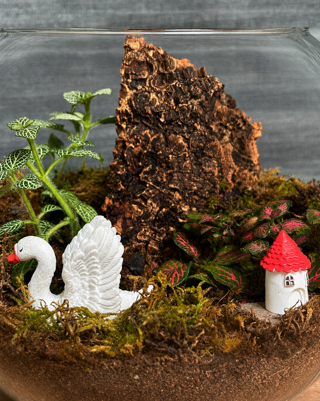 Handcrafted Swan & House Fish Bowl terrarium from Planterie plant studio in Delhi, a unique glass micro-garden with cute swan and house miniatures with live plants ideal as glass terrarium for gifting, tabletop plants for gifting, indoor plants for gifting and indoor plant gifts for housewarming in Delhi